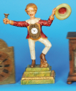 Geschnitztes, tanzendes Uhrmännchen, das seinen Hut schwenkt, Rollankergang und kurzem Vorderpendel